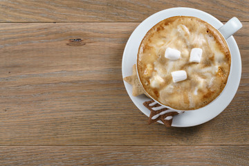 cup of cappuccino with homemade christmas cookies