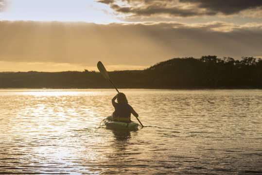 A kayaker paddles in the sunset on the south shore of Fernandina Island, Galapagos