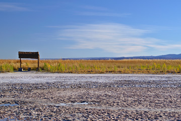 Salt lake rustic seat near grass plantation in a beautiful blue
