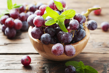 Sweet red grapes on the wooden table