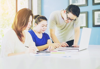 Obraz premium Vintage style photo of two women and one man are working in modern office