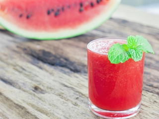 Fresh watermelon in a glass on old wooden background