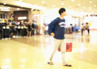 Blurred photo of a guy in a modern shopping center