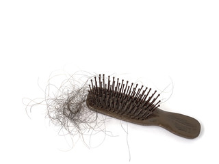 Hair loss stick at a comb isolated over white, hair treatment concept