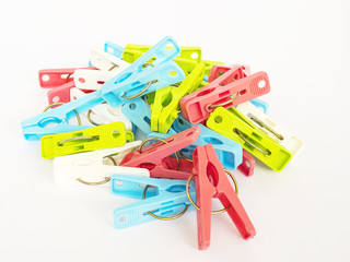 Colorful plastic clothespins over white background