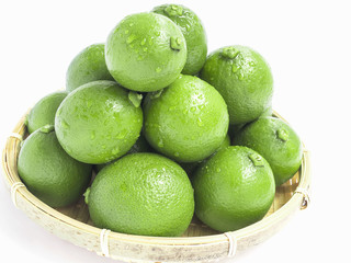 lime in the bamboo basket on white background