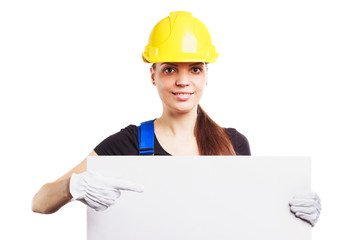 Woman builder in construction helmet with a placard
