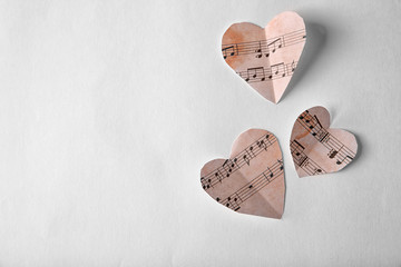 Paper hearts with music notes on white background