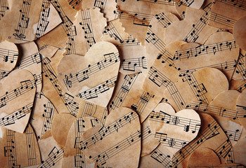 Paper hearts with music notes background