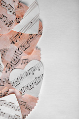 Paper hearts with music notes on white background