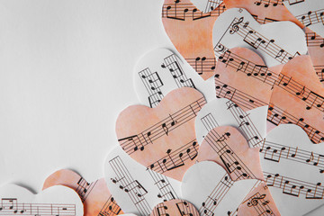 Paper hearts with music notes on white background