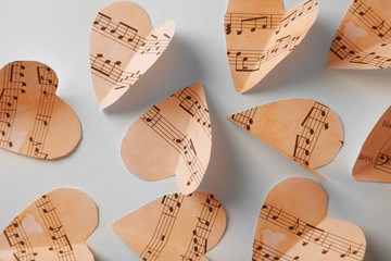 Paper hearts with music notes on white background