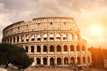 Fototapeta na wymiar Sunset lights the side of ancient amphitheater Colosseum, Rome,