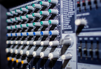 Part of an audio sound mixer with buttons and sliders
