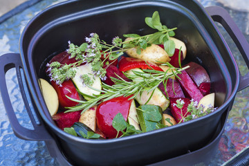 Raw vegetable with herbs ready for cooking in oven
