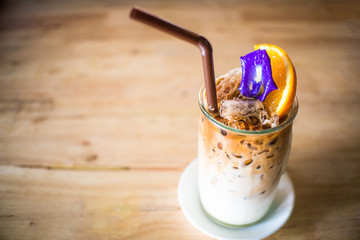 iced coffee With fresh milk on the bottom .Placed on a wooden table ready to serve you.