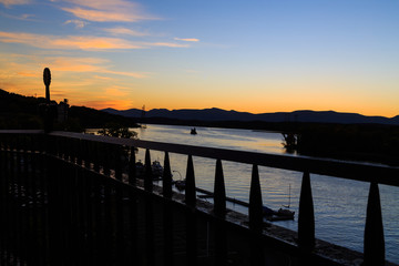 Hudson River at dusk in Hudson with lighthouse and boats