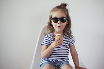 toddler girl have fun with ice cream