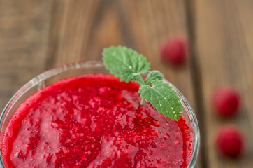 Close-up raspberry smoothie with mint on wood background