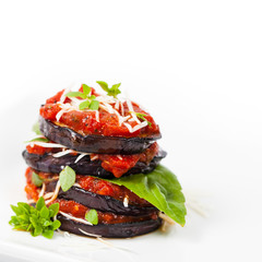 Layered Italian Eggplant Appetizer on White Background. Selective focus.