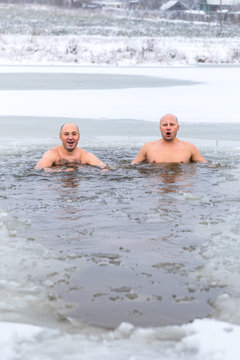 Winter swimming. Man in an ice-hole in outdoors