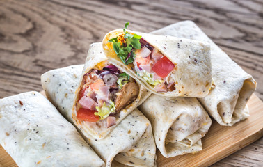 Chicken burritos on the wooden background