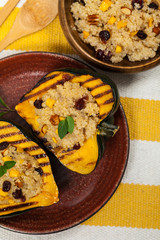 Pumpkin Acorn Stuffed with Quinoa, Nuts and Dried Fruit. Selective focus.