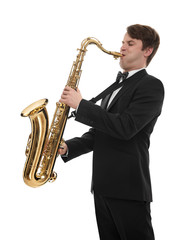 Saxophonist in a tuxedo plays music on sax.