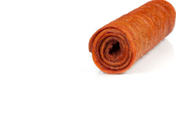 Candied fruit twisted in roll isolated on white background. Homemade sweetness of dried fruit.