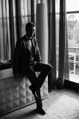 Groom sitting on the sofa in the room