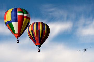 Fototapeta na wymiar hot air Ballons with an approaching plane 
