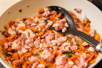 Small pieces of pork cooked in a pan