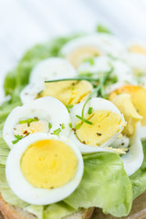 Old wooden table with sliced Eggs