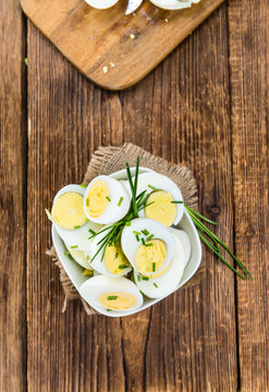 Wooden table with halved Eggs