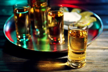 Rolgordijnen Gold tequila shot in bar © Africa Studio