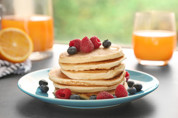 Plate full of tasty pancakes with berries