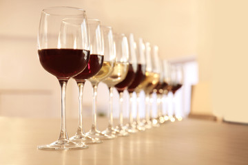 Glasses with red and white wine on table in restaurant