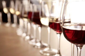 Glasses with red and white wine on table in restaurant