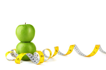 Fresh apples with measuring tape on white background