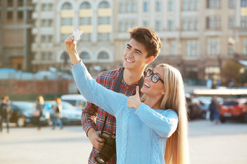 Young couple taking selfie, outdoors