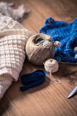 tools for knitting and handmade on wooden surface