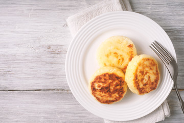 Three cheesecake on a white plate