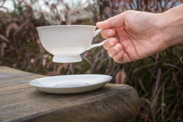 Coffee cup and tea On a Wooden table in the lawn garden.The visual style is warm Feeling relaxed