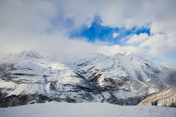 Picture of classic beautiful vibrant swiss landscape mountain road view with Alps mountains, bridge, cows, meadows and village, Switzerland

