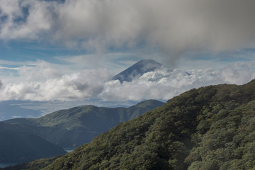 Hakone, Japan - September 27, 2016: The summit of mount Fuji visible and encircled by bands of...