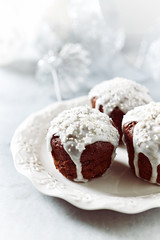 Chocolate muffins with icing and sugar pearls for Christmas

