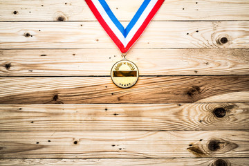 Award of Victory. Winners at the best games, gold medal On the wall of wood