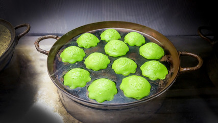 Thai Traditional dessert the name of "Kanom Krok Bai Toey(or Knmcrk) "  in ancient pan.
