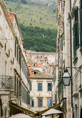 Fototapeta na wymiar The scenic cable car that carries people to the top of Mount Srd in Dubrovnik, Croatia, is visible through the buildings of the old town.