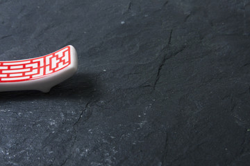 Red chopsticks on stone slate